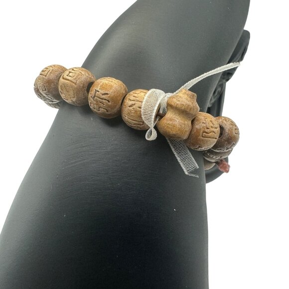 Hand-Carved Wooden Look Bead Bracelet With Intricate Symbols - Picture 2 of 5